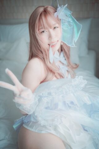 Saucy South Korean girl posing seductively in her white dress and stockings